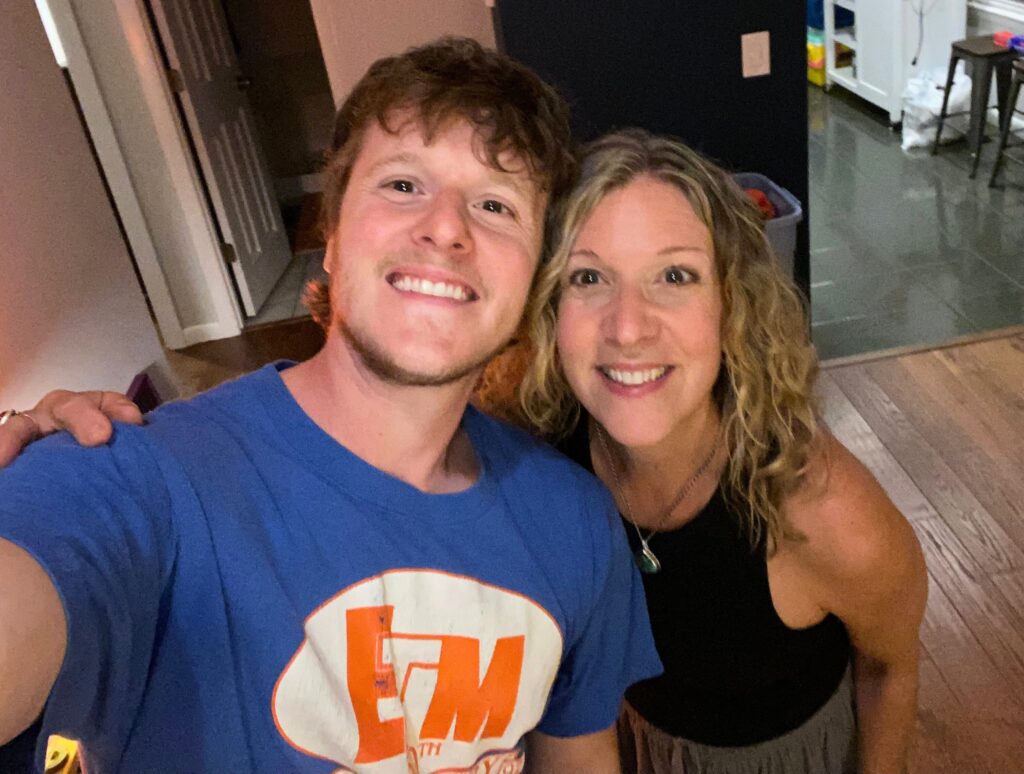 Heidi Schauster and her younger brother John in her kitchen, reflecting the sibling collaboration behind her viral Instagram reels.
